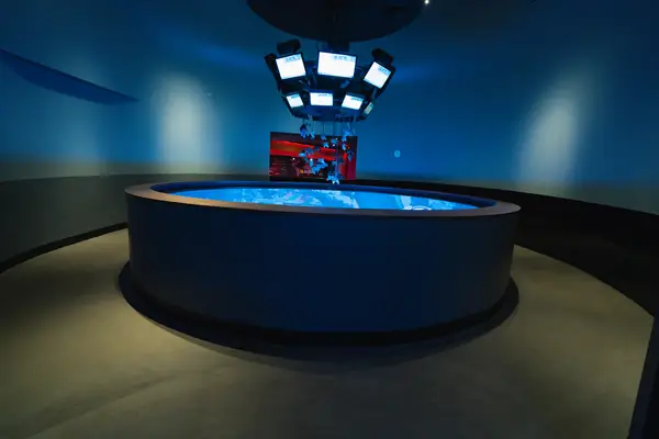Circular stage desk lit in blue